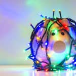 Piggy bank wrapped in Christmas string lights