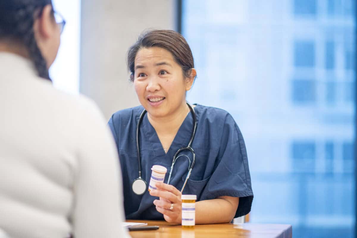 Nurse talks with a teenager about medication