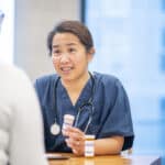 Nurse talks with a teenager about medication