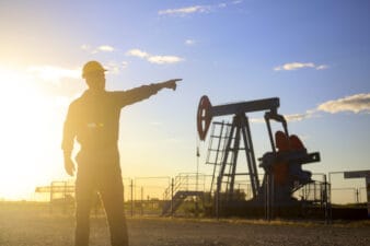 Oil industry worker works in oilfield