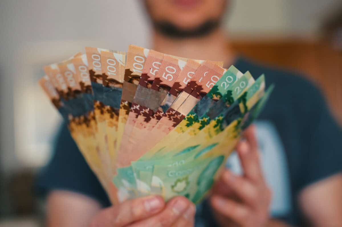 Person holds banknotes of Canadian dollars