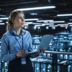 Data center woman holding laptop