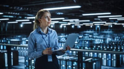 Data center woman holding laptop