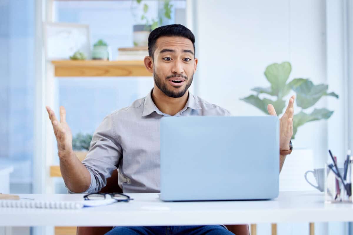 Person pleasantly surprised with laptop