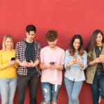 young people stare at smartphones