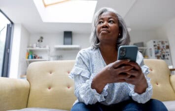 woman looks at iPhone