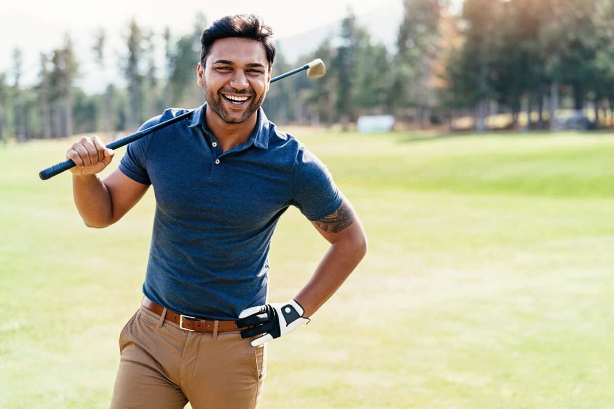 Happy golf player walks the course