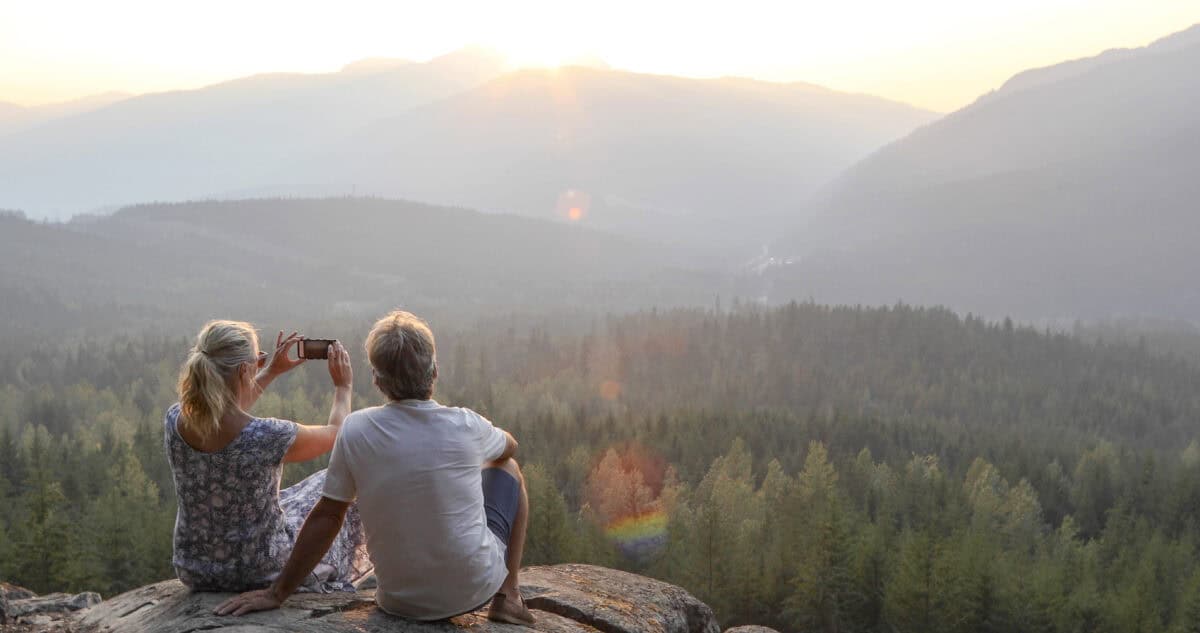 people relax on mountain ledge