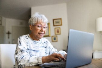 Senior uses a laptop computer