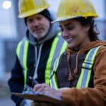 construction workers talk on the job site