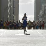 Woman running in front of pack in marathon