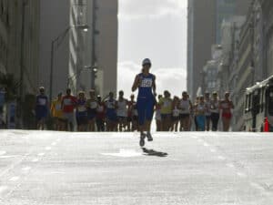 Woman running in front of pack in marathon